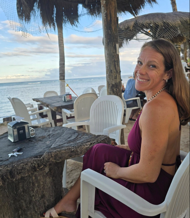 Melanie at the beach, smiling